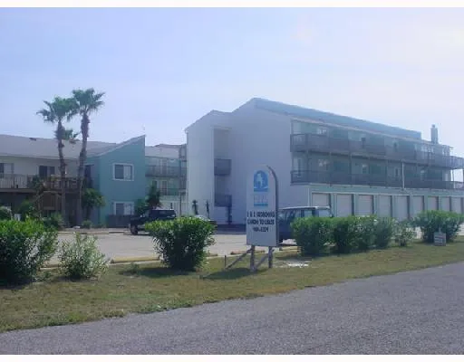 a brick building with a yard in front of it