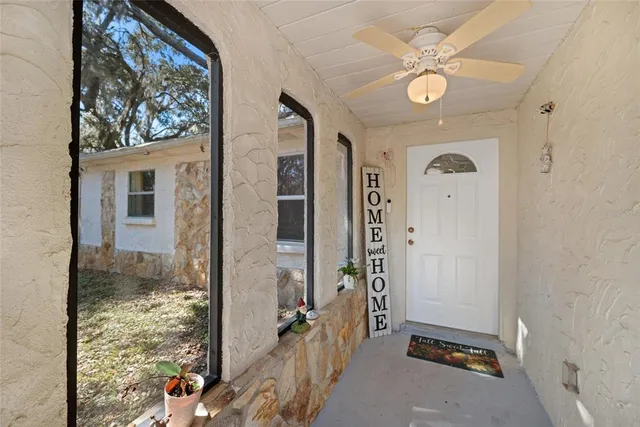 a living room with furniture and a dining table