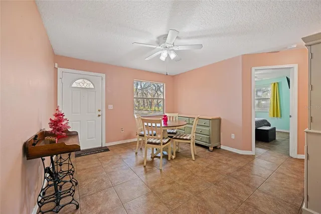 a dining room with furniture and kitchen view