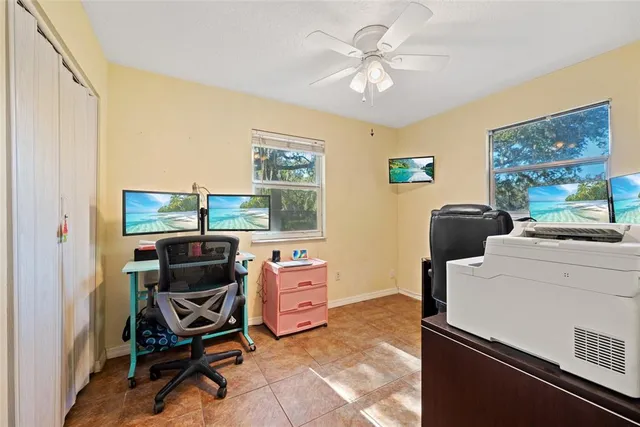 a view of a workspace with furniture and a window