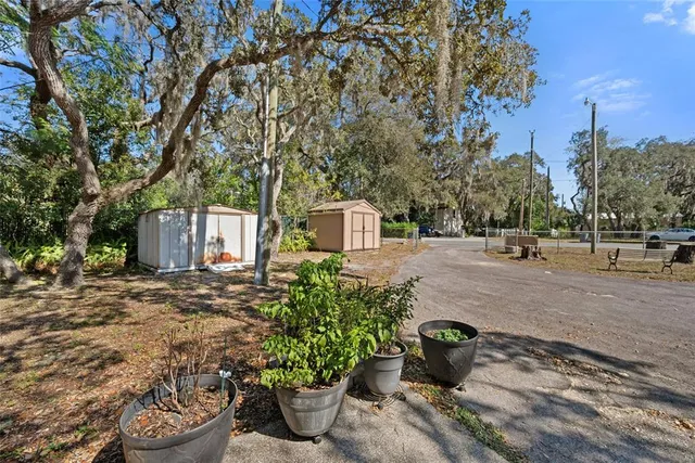 a view of a backyard with table and chairs under an umbrella