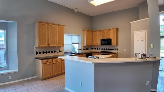 a kitchen with stainless steel appliances granite countertop a sink stove and cabinets