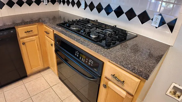 a close view of a stove a microwave and a sink in a kitchen
