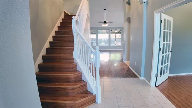 a view of staircase with white walls and windows