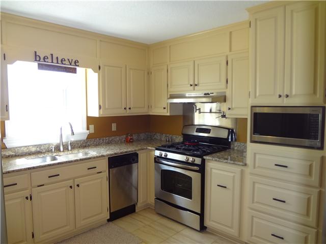360 Beasley Branch Road Prospect, TN 38477 - Photo 8 of 20 a kitchen with granite countertop white cabinets and white appliances