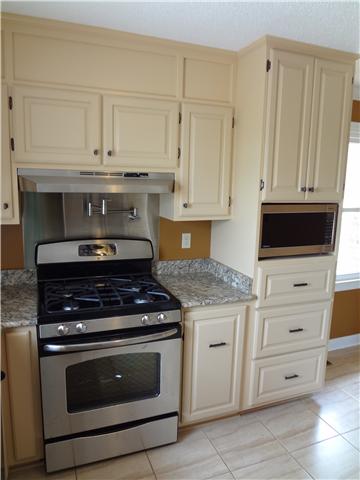 360 Beasley Branch Road Prospect, TN 38477 - Photo 9 of 20 a kitchen with granite countertop white cabinets and stainless steel appliances