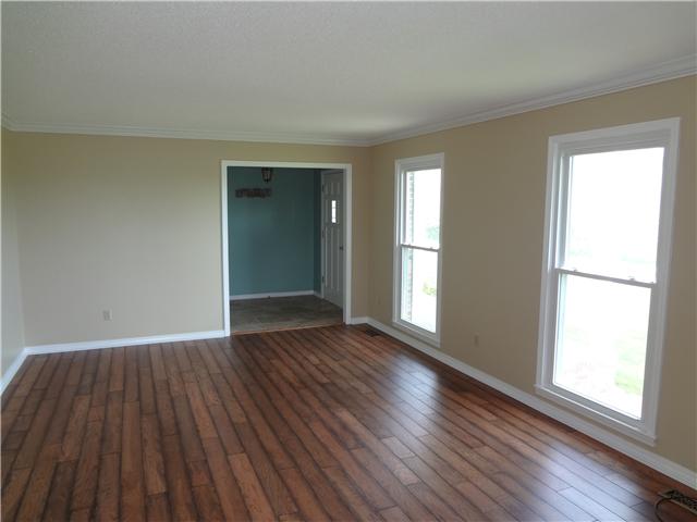 360 Beasley Branch Road Prospect, TN 38477 - Photo 10 of 20 an empty room with wooden floor and windows