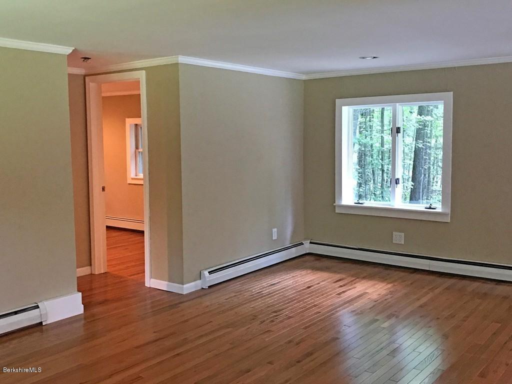 122 Davenport Road Rowe, MA 01367 - Photo 8 of 22 an empty room with wooden floor and windows