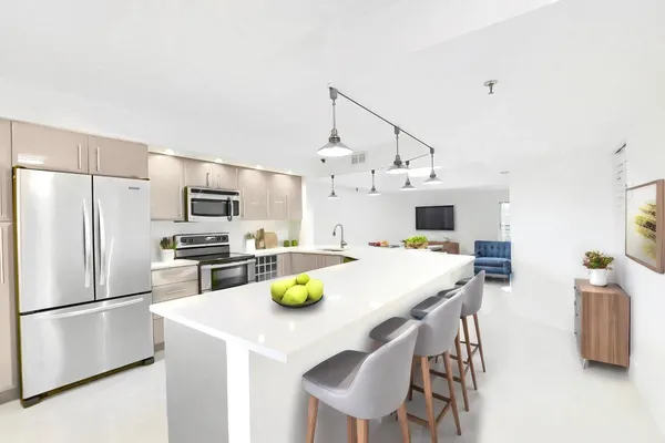 a kitchen with stainless steel appliances a dining table and chairs