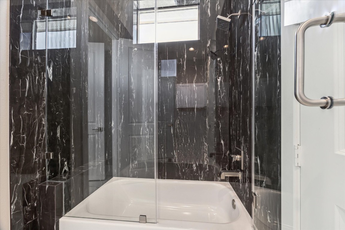 5613 Leonard Street Houston, TX 77023 - Photo 14 of 21 a bathroom with shower and bathtub