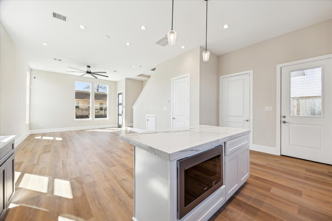 5613 Leonard Street Houston, TX 77023 - Photo 4 of 21 a kitchen with a stove and a wooden floor