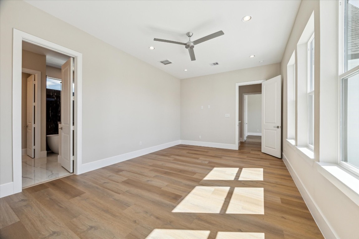 5613 Leonard Street Houston, TX 77023 - Photo 7 of 21 wooden floor in an empty room with a window