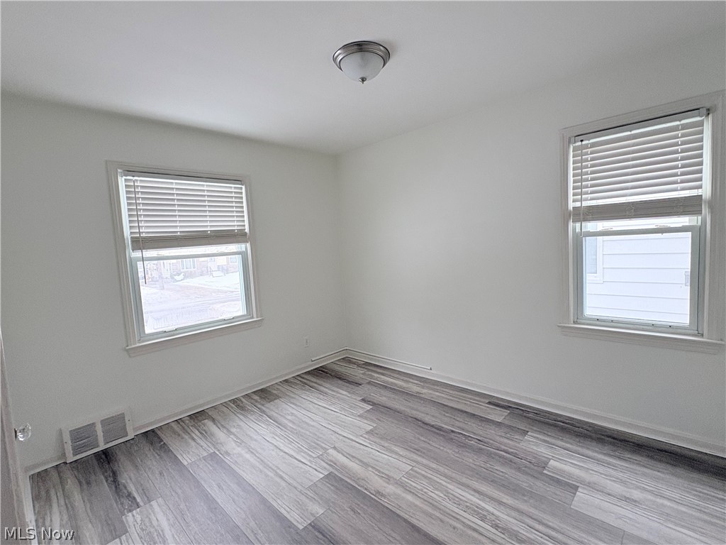 15521 Corkhill Road Maple Heights, OH 44137 - Photo 12 of 33 Empty room featuring light wood-style flooring and baseboards