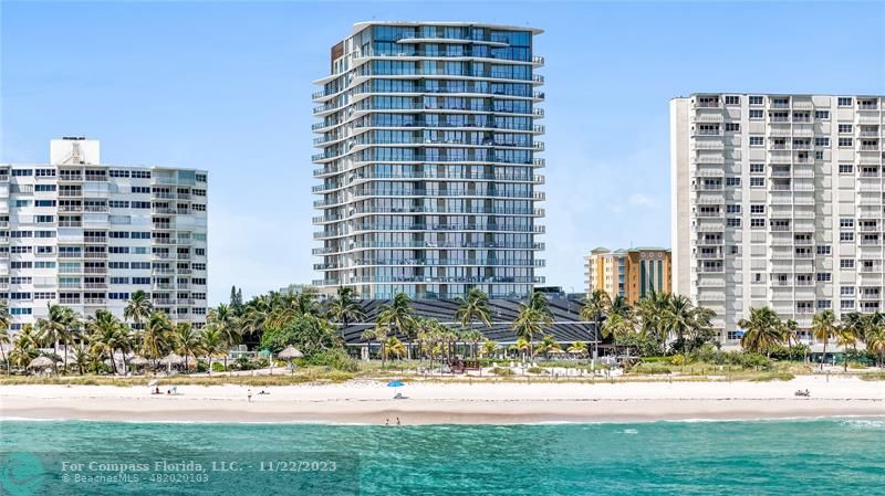 730 North Ocean Boulevard, Unit 702 Pompano Beach, FL 33062 - Photo 1 of 29 a front view of a building with a yard