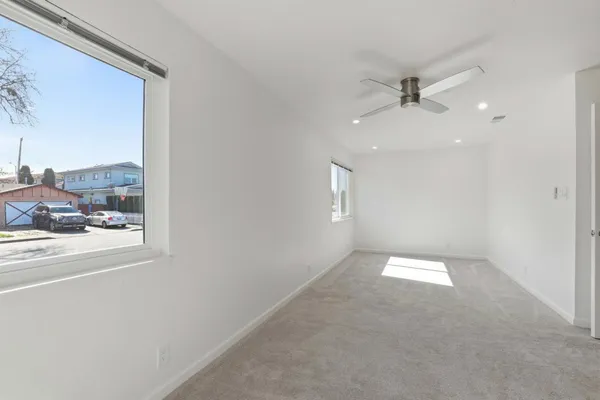 a view of an empty room and a window