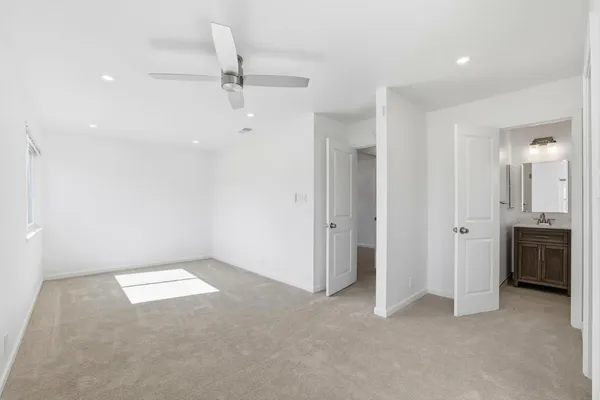 an empty room with a bathroom and a sink
