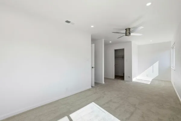 a view of a big room with closet and windows
