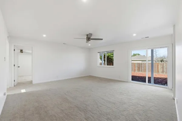 an empty room with windows and an entrance