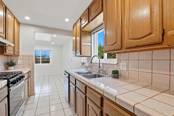 a kitchen with stainless steel appliances a sink stove and cabinets