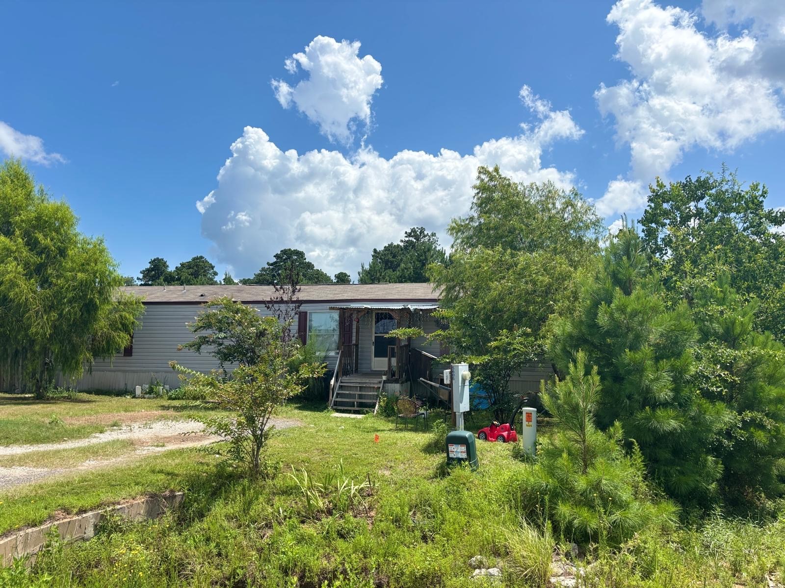 5605 Frst Vista Court Conroe, TX 77306 - Photo 29 of 34 a view of a house with a yard and a tree