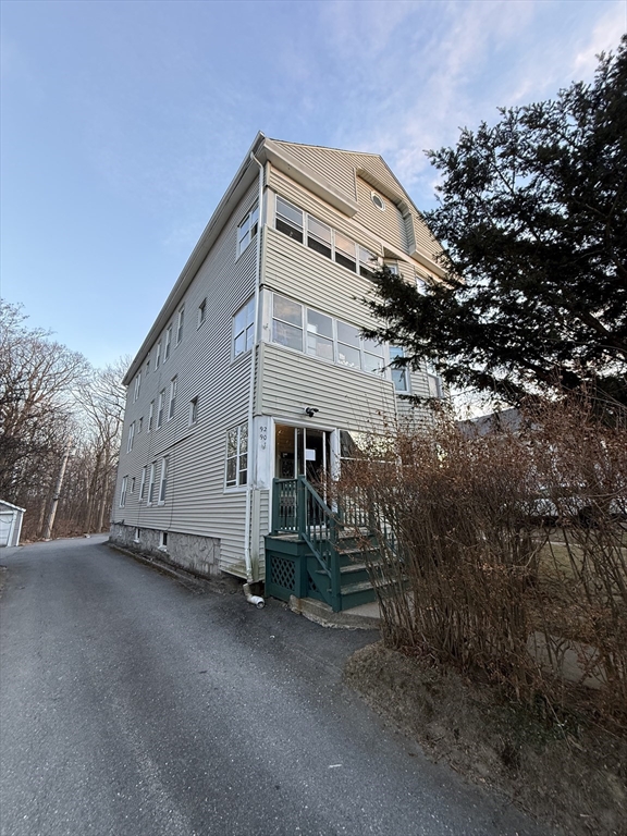92 Stanton Street, Unit 3 Worcester, MA 01605 - Photo 1 of 18 a view of a house with a tree