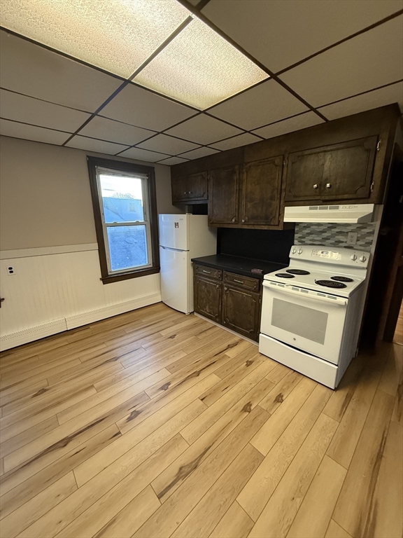 92 Stanton Street, Unit 3 Worcester, MA 01605 - Photo 11 of 18 a kitchen with wooden floors and appliances