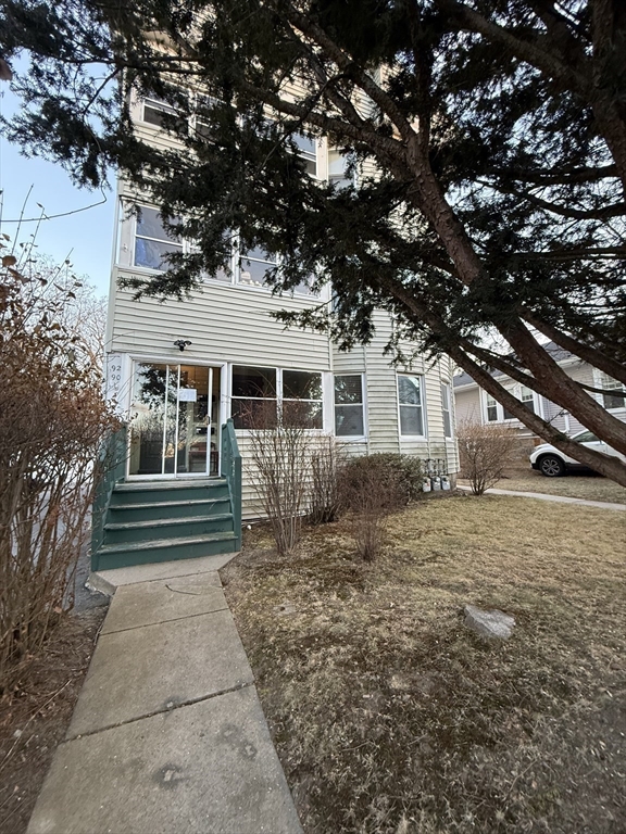92 Stanton Street, Unit 3 Worcester, MA 01605 - Photo 2 of 18 a front view of a house with a yard
