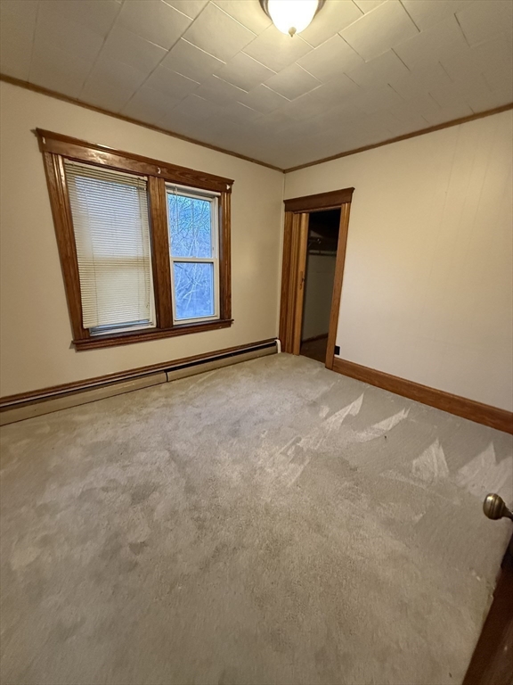 92 Stanton Street, Unit 3 Worcester, MA 01605 - Photo 7 of 18 a view of an empty room with window and stairs