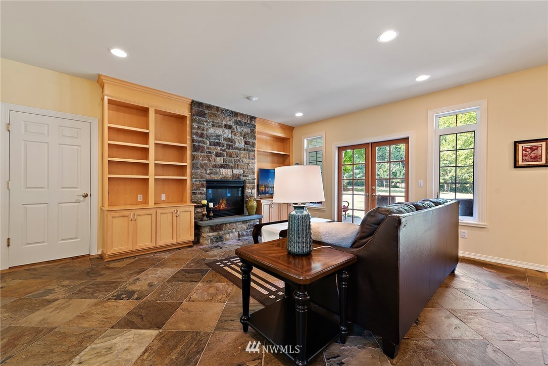 18416 Southeast 195th Place Renton, WA 98058 - Photo 13 of 32 a living room with furniture a fireplace and a table