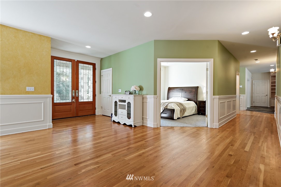 18416 Southeast 195th Place Renton, WA 98058 - Photo 15 of 32 a view of a big room with wooden floor and windows