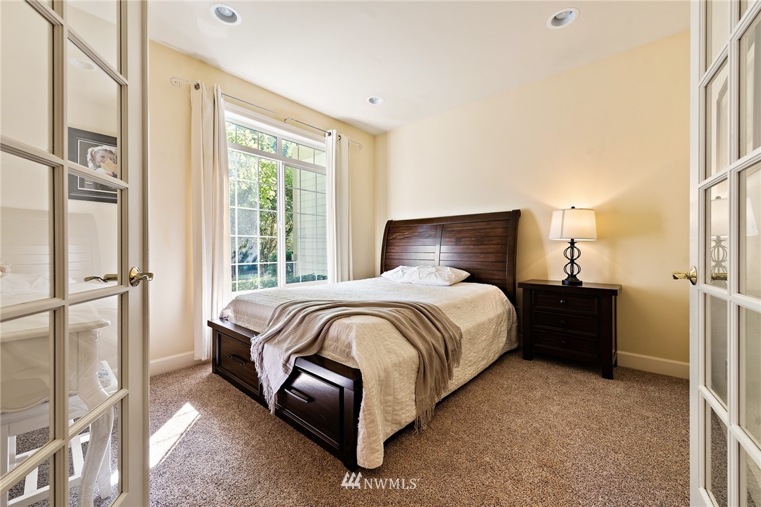 18416 Southeast 195th Place Renton, WA 98058 - Photo 16 of 32 a bed sitting in a bedroom next to a window