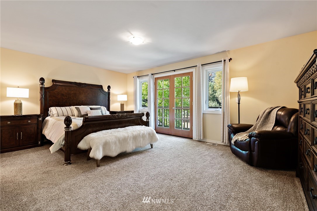 18416 Southeast 195th Place Renton, WA 98058 - Photo 18 of 32 a bed room with a bed and a night stand