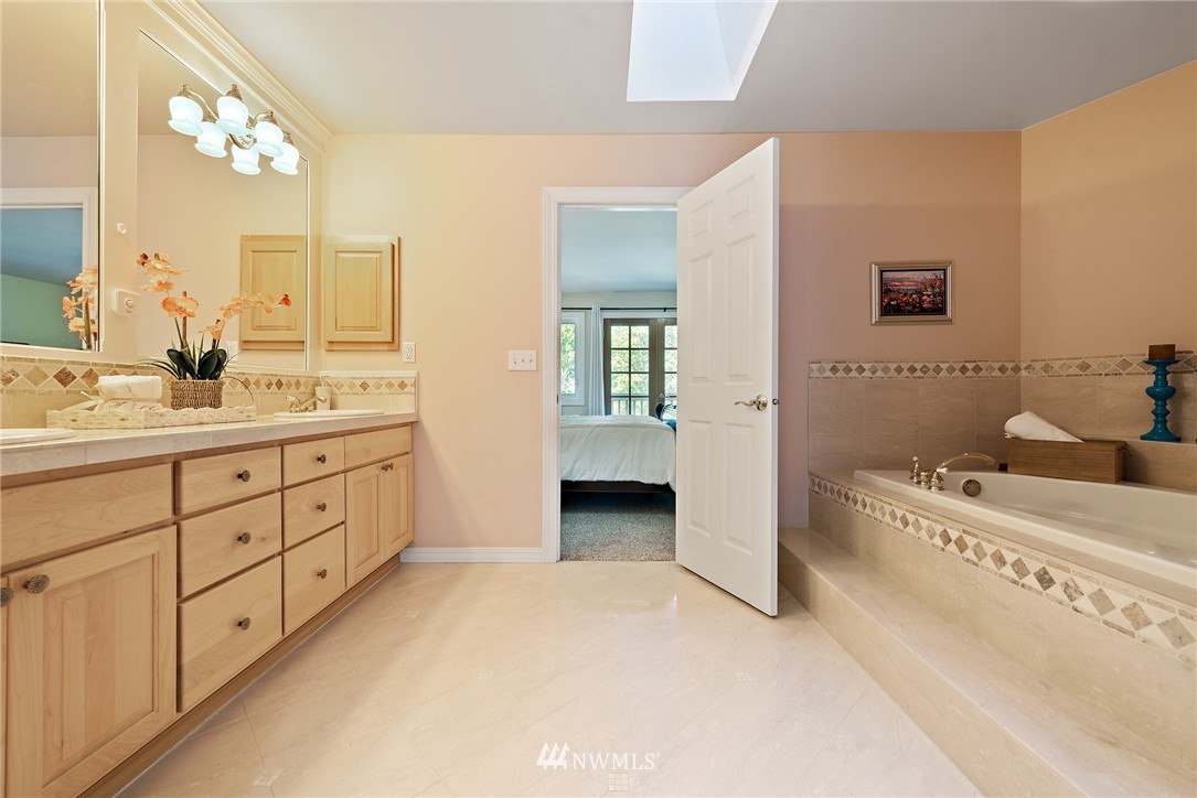 18416 Southeast 195th Place Renton, WA 98058 - Photo 20 of 32 a spacious bathroom with a double vanity sink and mirror