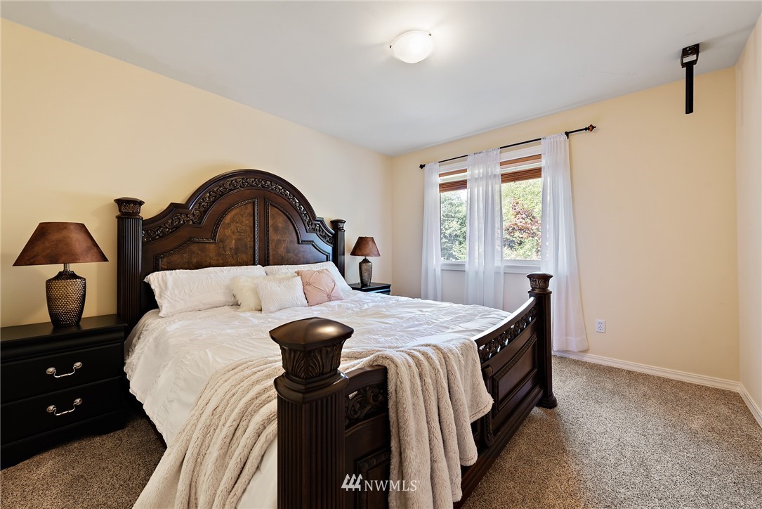 18416 Southeast 195th Place Renton, WA 98058 - Photo 22 of 32 a bed sitting in a bedroom next to a window