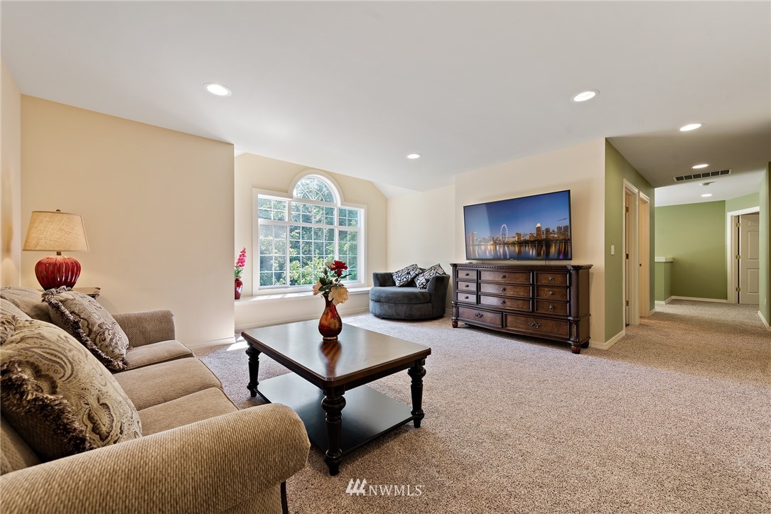 18416 Southeast 195th Place Renton, WA 98058 - Photo 25 of 32 a living room with furniture and a flat screen tv