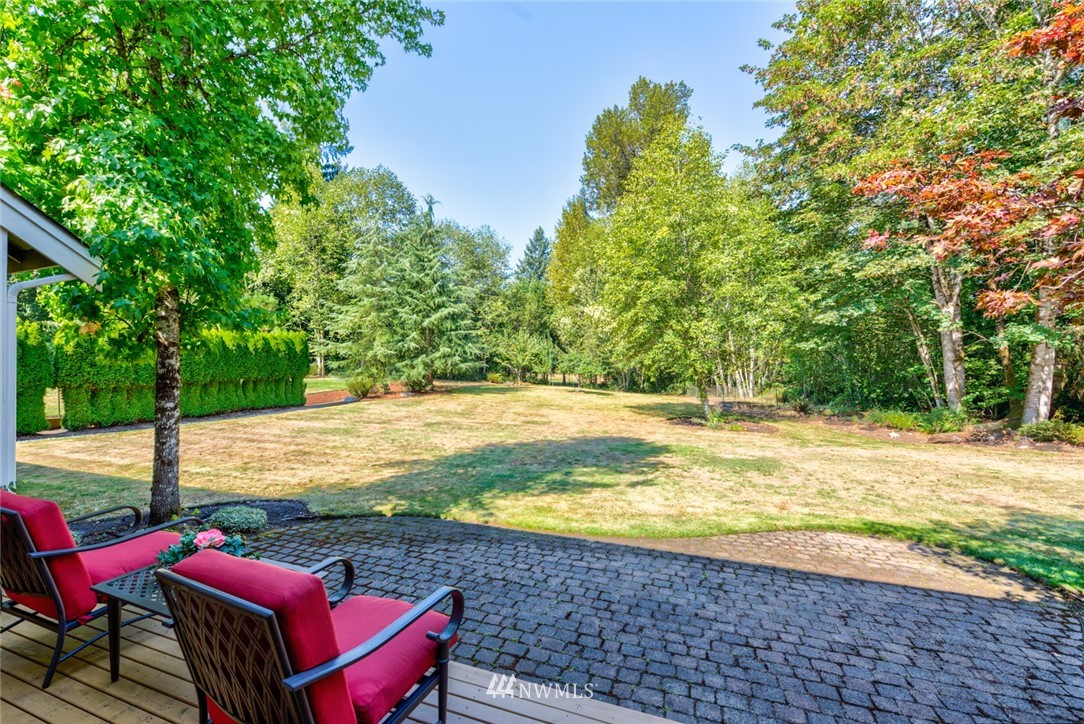 18416 Southeast 195th Place Renton, WA 98058 - Photo 30 of 32 a view of a swimming pool with red chairs in front of house