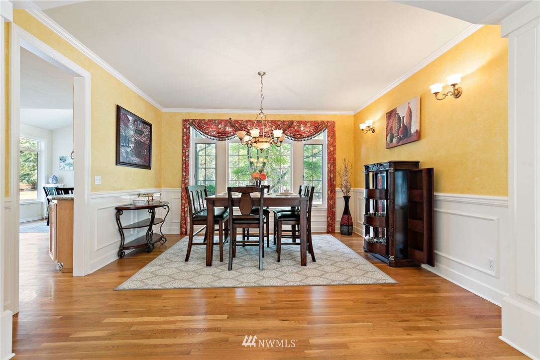 18416 Southeast 195th Place Renton, WA 98058 - Photo 7 of 32 a view of a dining room with furniture window and wooden floor
