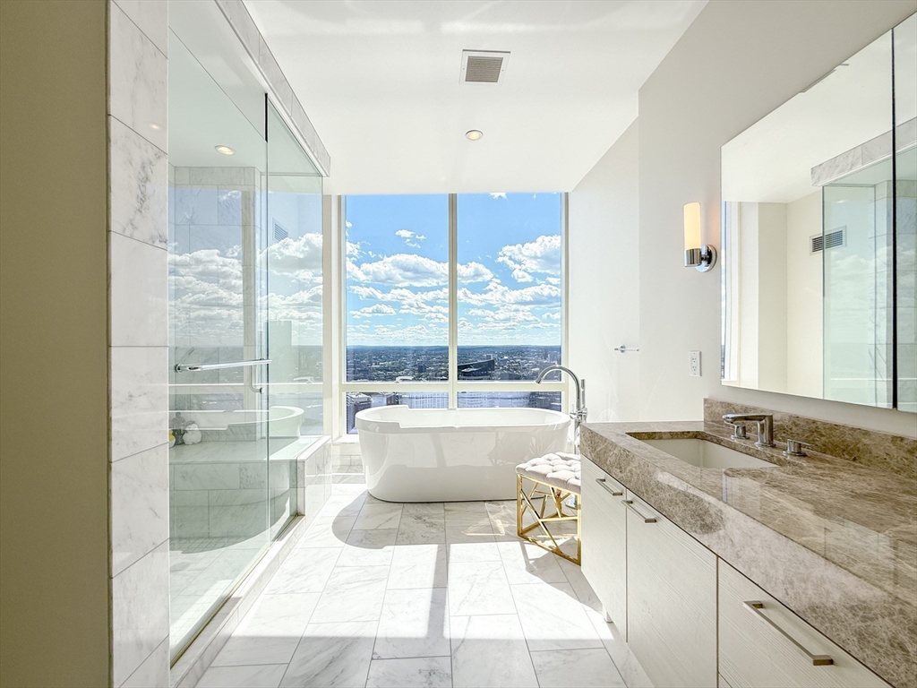 a spacious bathroom with a granite countertop sink and a large mirror
