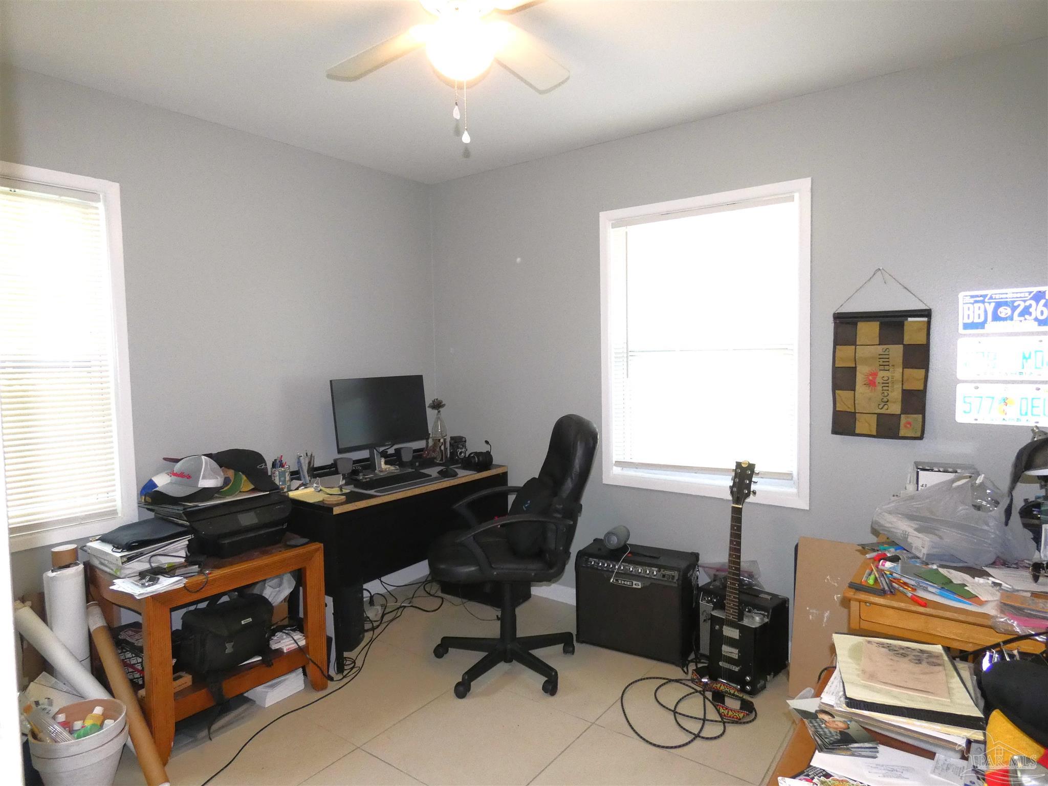 7704 West Gadsden Street Pensacola, FL 32506 - Photo 16 of 18 a view of a workspace with furniture and a window