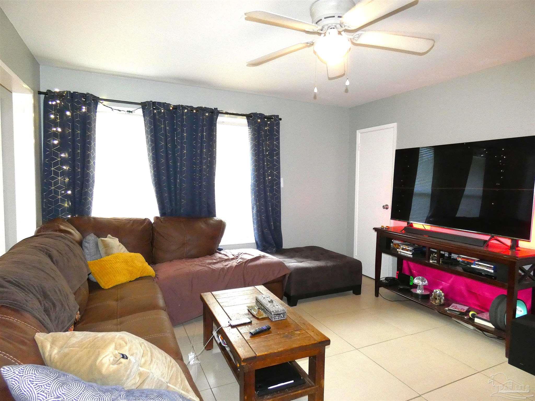 7704 West Gadsden Street Pensacola, FL 32506 - Photo 10 of 18 a bedroom with a bed and window