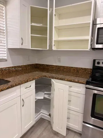 a view of a refrigerator in kitchen
