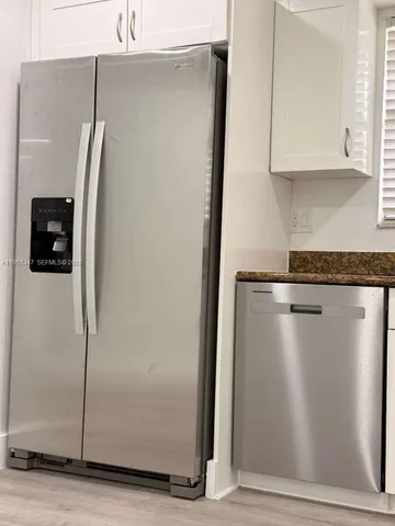 a view of kitchen with sink and microwave