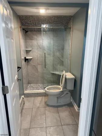 a bathroom with a toilet and a shower