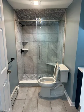 a bathroom with a toilet and a shower