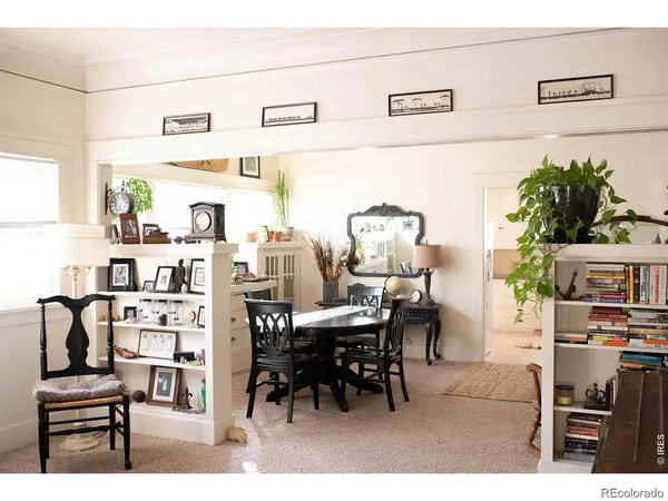 a view of a dining room with furniture and a potted plant