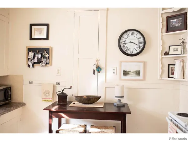 a view of a workspace with a table and a clock