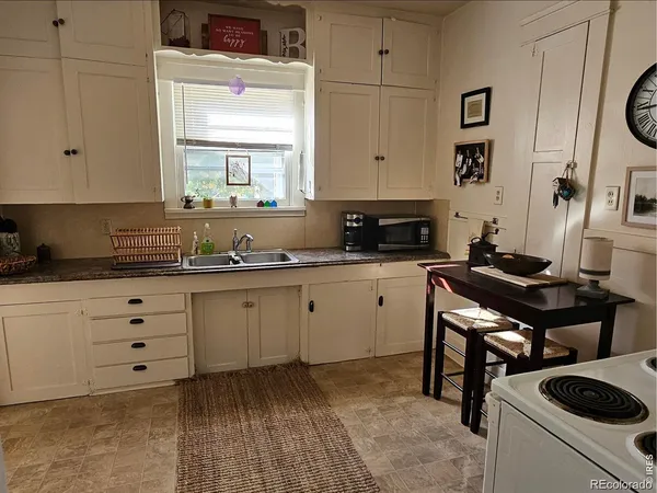 a kitchen with cabinets appliances and a window