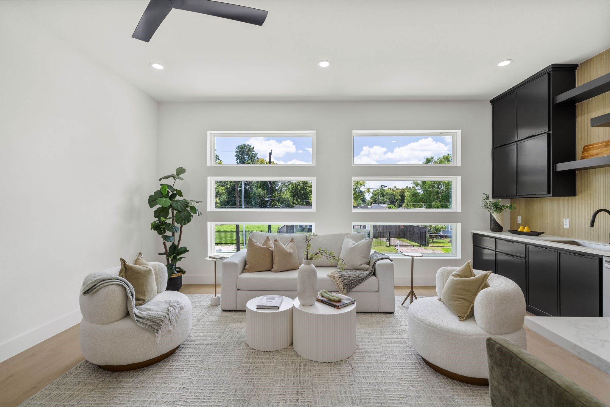 7321 Laura Koppe Road Houston, TX 77028 - Photo 3 of 41 Bright and modern living space with largewindows,cozy seating, and sleek black cabinetry,offering aperfect blend of comfort and style.