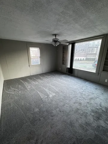 an empty room with windows and entrance