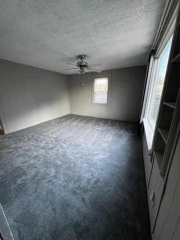 an empty room with windows and entrance